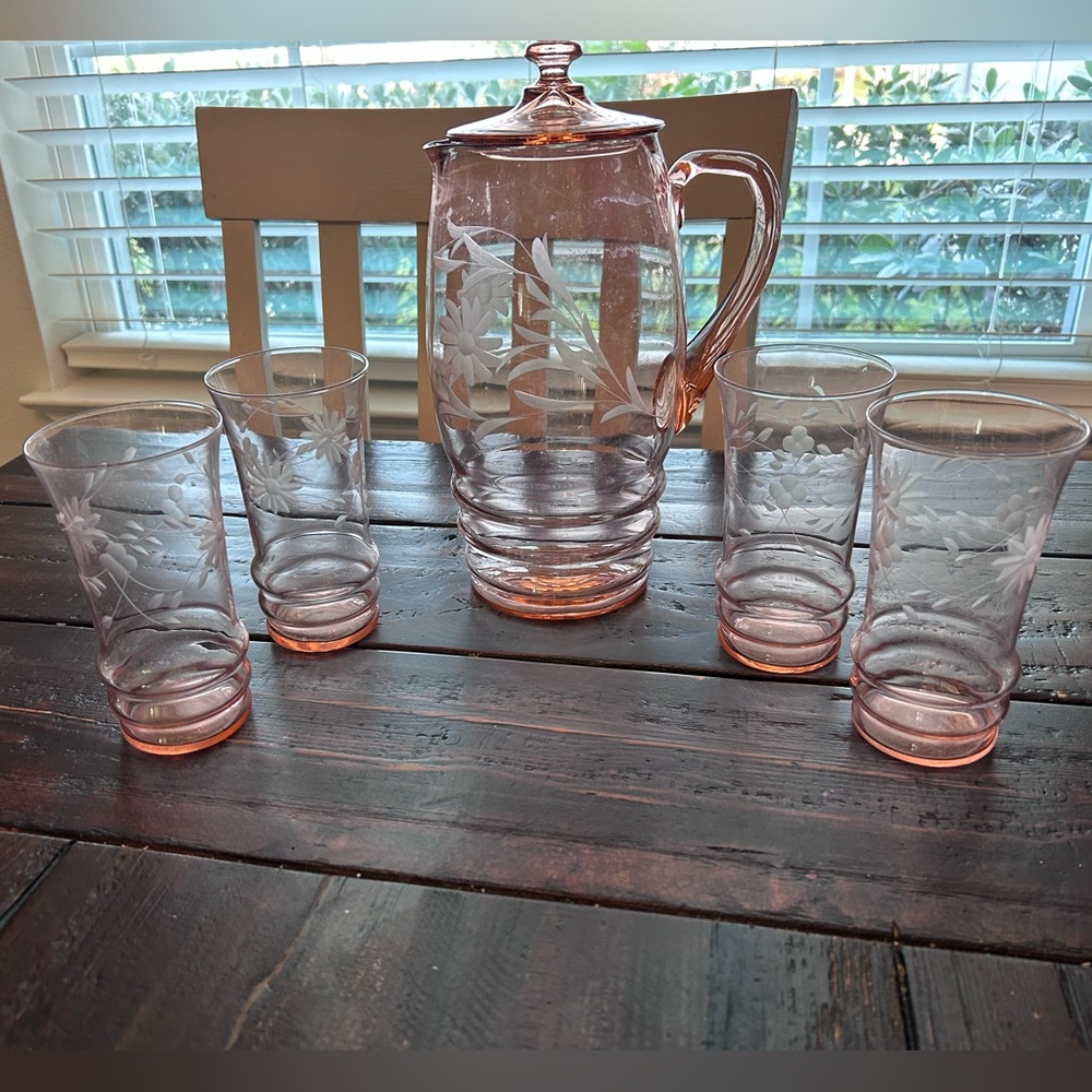 Pink depression glass pitcher with lid and set of four matching glasses